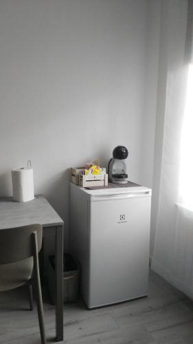 a small white refrigerator sitting next to a table at Corte Disore in Rivolto