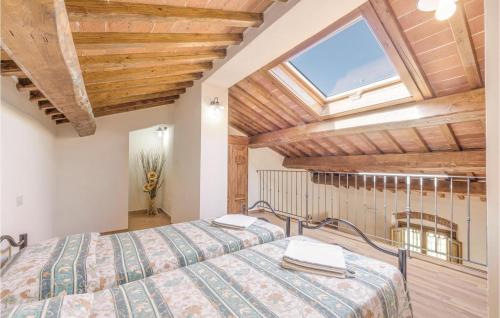 a bedroom with two beds and a large window at Muraiolo in Lamporecchio