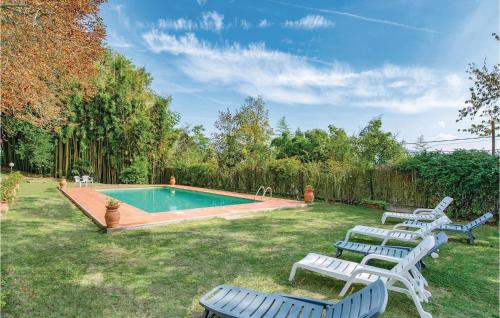 a group of lawn chairs and a swimming pool at Villa Di Collina in Vicchio