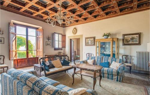 a living room with blue couches and a table at Villa Di Collina in Vicchio