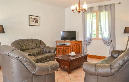 a living room with leather chairs and a tv at Lovely Home In Savignac-Ledrier in Payzac