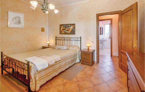 a bedroom with a large bed and a bathroom at Lovely Apartment In Cecina Li in Fiorino