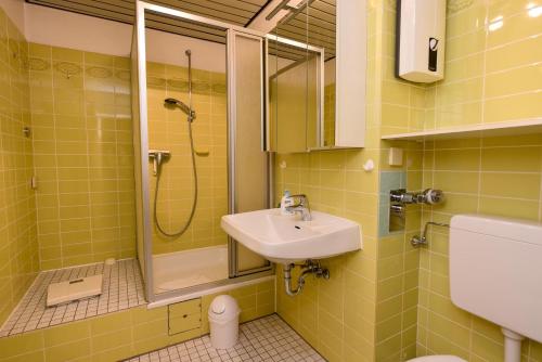 a bathroom with a sink and a shower at Haus "Panorama" Appartement PAN068 in Duhnen