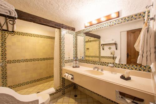 a bathroom with a sink and a mirror at Hotel Museo Spa Casa Santo Domingo in Antigua Guatemala