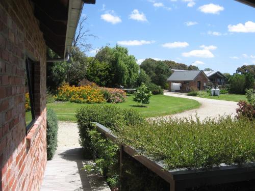 a view of a garden from the side of a house at Prom Coast Holiday Lodge in Waratah Bay