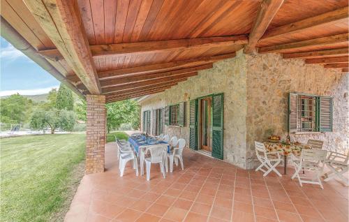 a patio with a table and chairs under a wooden ceiling at Villa Il Casale in Sperlonga