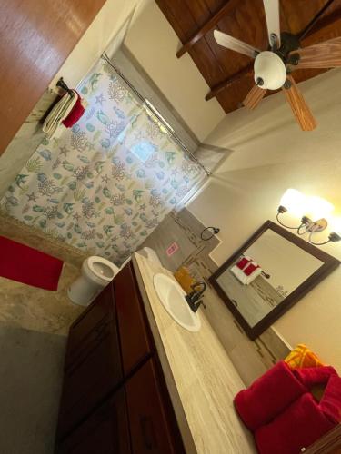 a bathroom with a sink and a ceiling fan at Ocean View Villas in Jost Van Dyke