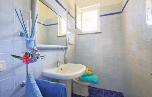 a bathroom with a sink and a toilet and a mirror at Maremma in Principina a Mare