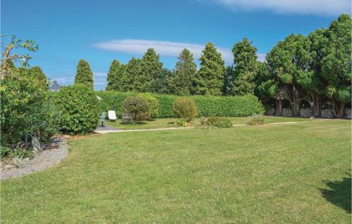 a garden with a lawn and trees in the background at 3 Bedroom Gorgeous Home In Plouaret in Plouaret