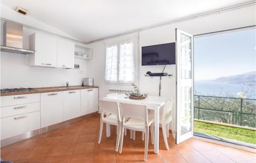 a kitchen with a table and a view of the ocean at Casa Morgana in Boschetto