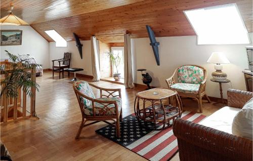 a living room with chairs and a table at Beautiful Home In Clohars Carnoet in Clohars-Carnoët