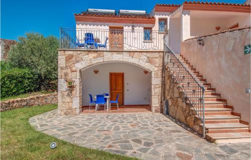 a house with a balcony and a patio at Trilo 6 in Budoni