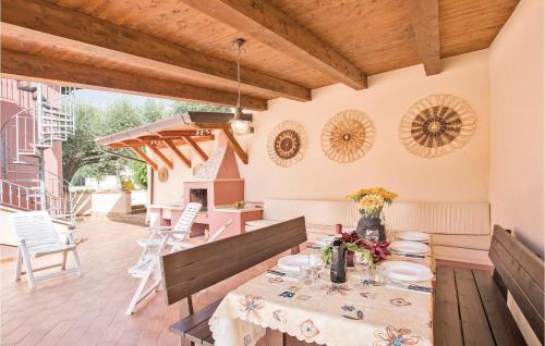 a dining room with a table and chairs on a patio at Villa Anna in Capo Vaticano