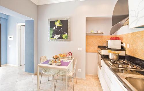 a small kitchen with a table and a stove at Villa Anna in Capo Vaticano