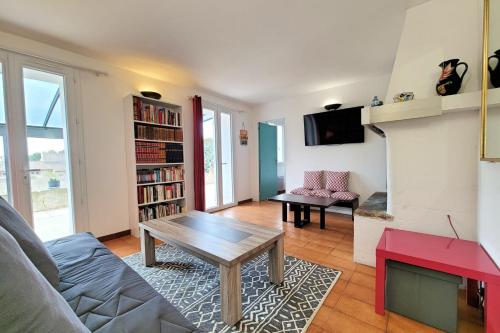a living room with a couch and a table at Apartment Comfort Terrace Garden Wifi in Saint-Cyr-sur-Mer