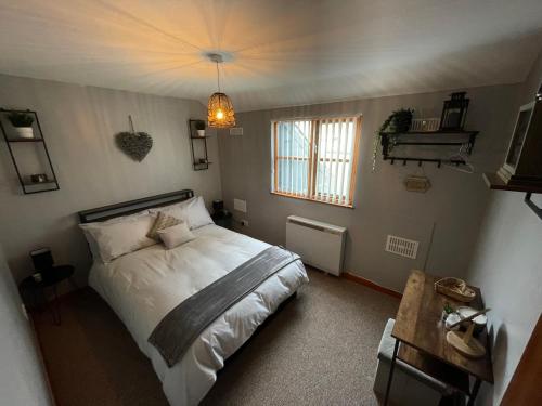 a bedroom with a bed and a window at Westend Holiday Let 3 Brecon in Brecon