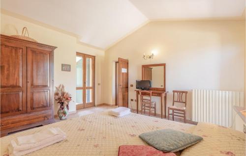 a large room with a large bed and a table at Pet Friendly Apartment in Giano dellʼUmbria