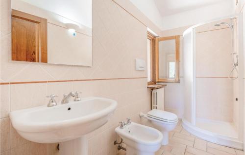 a white bathroom with a sink and a toilet at Lovely Apartment In Giano Dellumbria Pg With Kitchenette in Giano dellʼUmbria