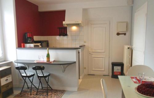 a kitchen with a counter and two bar stools at Gorgeous Apartment In Vildé-La-Marine in Vildé la Marine