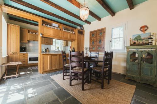 a kitchen with a table and chairs in a room at The Beach House in Néa Péramos