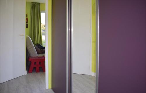 a room with purple and yellow walls and a doorway at Stunning Apartment In Trevou Treguignec in Trévou-Tréguignec