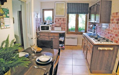 a kitchen with a table and a counter top at 2 Bedroom Beautiful Home In Embry in Embry