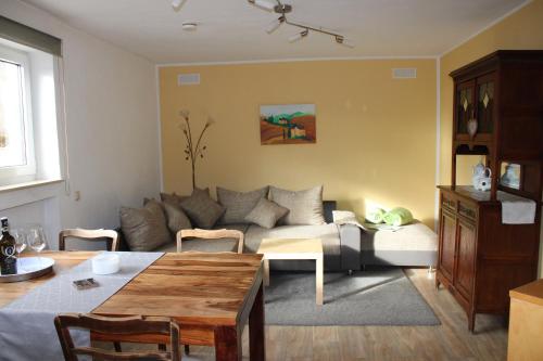 a living room with a couch and a table at Ferienwohnung Am Eifelsteig, Golbach in Kall