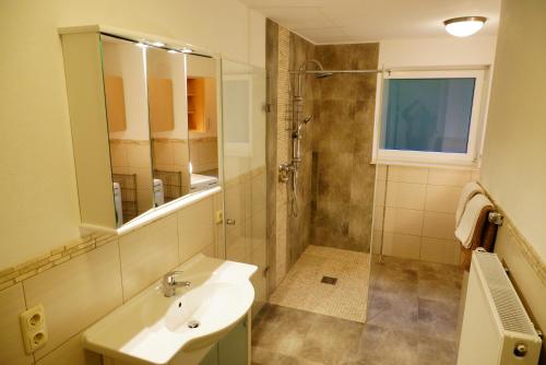 a bathroom with a sink and a shower at Ferienwohnung Am Eifelsteig, Golbach in Kall