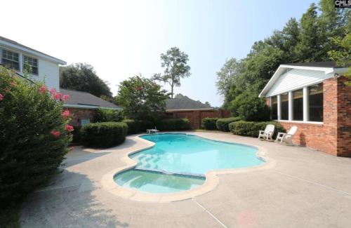 a swimming pool in the backyard of a house at Welcome to Columbia!-enjoy this tranquil space in Columbia