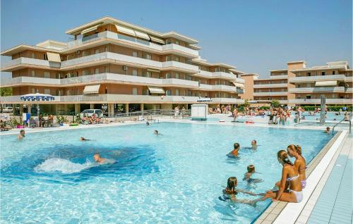 a group of people in a swimming pool at a hotel at Beautiful Apartment In Bibione With Outdoor Swimming Pool in Bibione