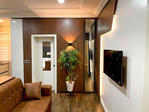 a living room with a couch and a plant at Whytescape Serviced Apartments in Abuja