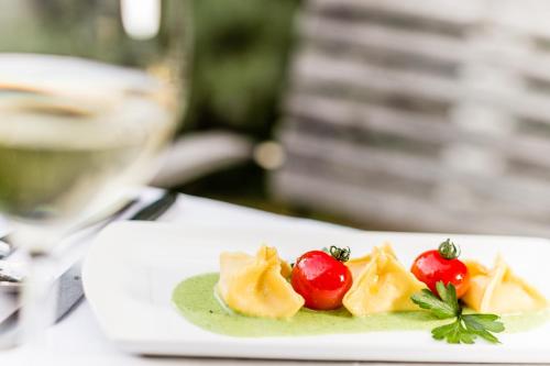 a plate of food with tomatoes on a table at Hotel Braunsbergerhof in Lana