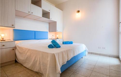 una camera da letto con un grande letto con cuscini blu di Pet Friendly Home In Cavo With House Sea View a Cavo