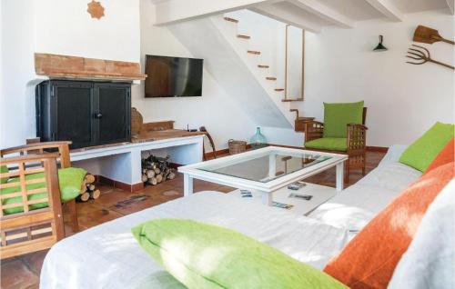 a living room with two chairs and a table at Gorgeous Home In Cádiz With Wifi in El Gastor