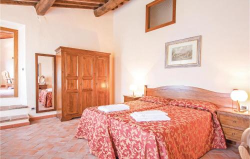 a bedroom with a bed with a red bedspread at Sangiovese 6 in San Donato in Poggio
