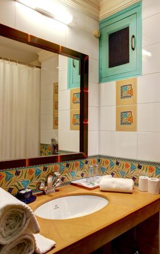 a bathroom with a sink and a mirror at Palace On Ganges - Heritage Hotel in Varanasi