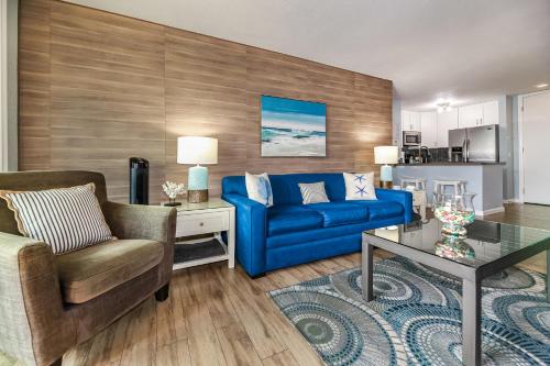 a living room with a blue couch and a table at C112 - Pier Pleasure in Oceanside