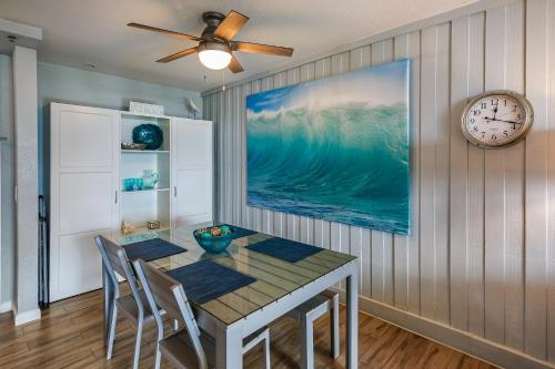 a dining room with a table and a clock at C112 - Pier Pleasure in Oceanside