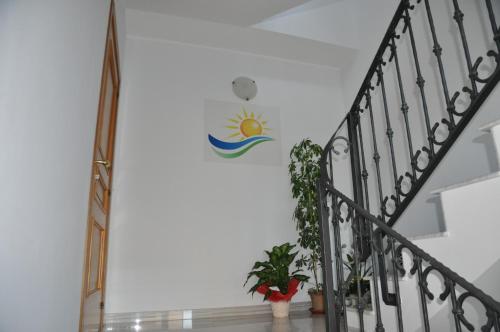 a staircase with a sun wall sticker on the wall at Domus Primavera in Scerne
