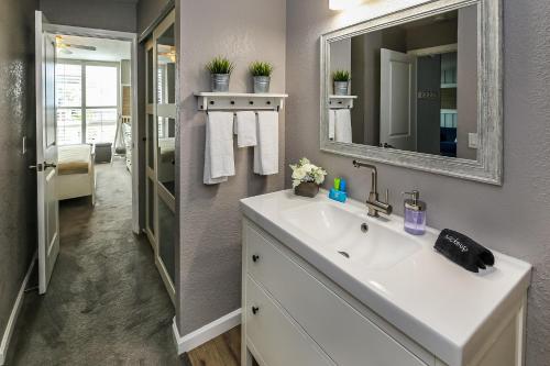 a bathroom with a sink and a mirror at C112 - Pier Pleasure in Oceanside