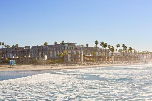 a building on the beach with the ocean in front of it at D313 - Sea Blue in Oceanside