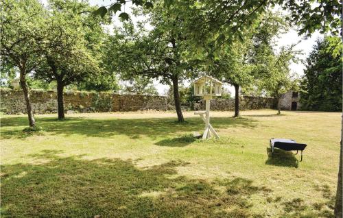 a bird house and a bench in a park at Holiday Home Château De Bremesnil P-836 in Saint-Germain-du-Crioult