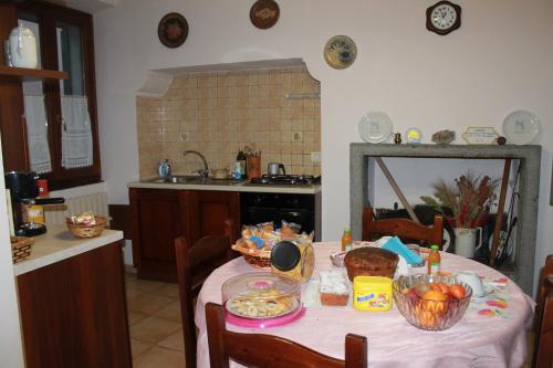 a kitchen with a table with food on it at La Loggetta in Bagnoregio