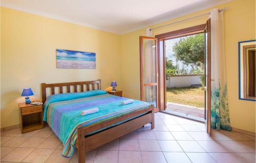 a bedroom with a bed and a sliding glass door at Villa Sarah in Ioppolo