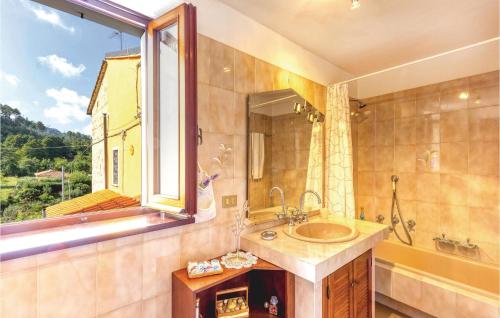 a bathroom with a sink and a window at Cozy Apartment In Marignana lu With Kitchen in Corsanico-Bargecchia