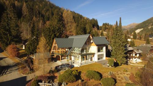 an aerial view of a large house in the mountains at Apartment Bad Kleinkirchheim in Bad Kleinkirchheim