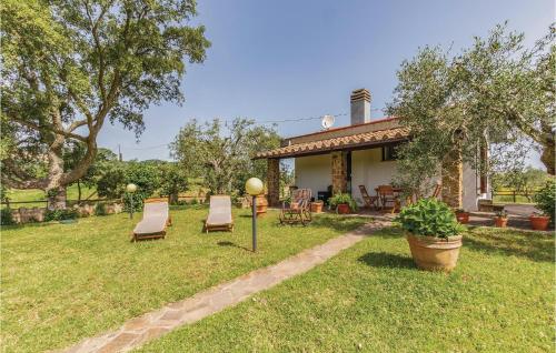 a yard with two chairs and a house at Sughereto 2 in Caldana