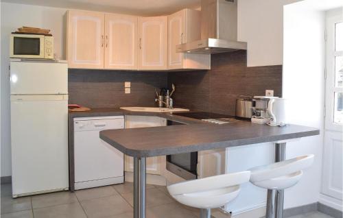 eine Küche mit Theke und weißem Kühlschrank in der Unterkunft Gorgeous Apartment In Ponts With Wifi in Ponts