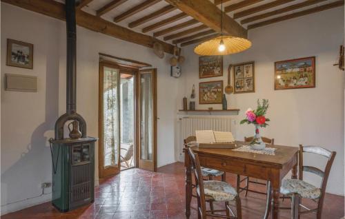 a living room with a wood stove and a table at Gorgeous Home In Bagni Di Lucca Lu in Bagni di Lucca