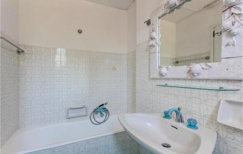 a bathroom with a sink and a tub and a mirror at Castello Mortellito in Spadafora